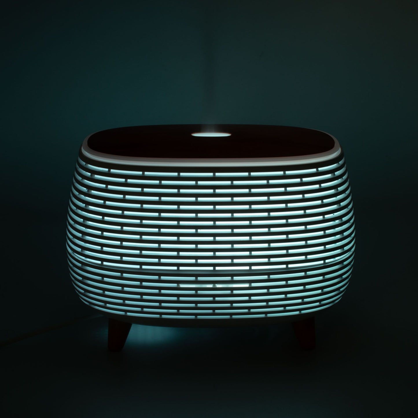 Futuristic ribbed aroma diffuser with color-changing light.