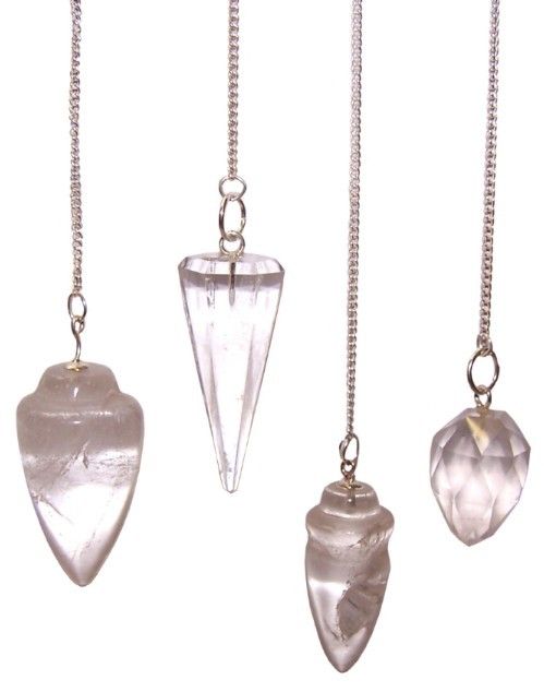 Four clear quartz crystal pendulums hang from silver chains.