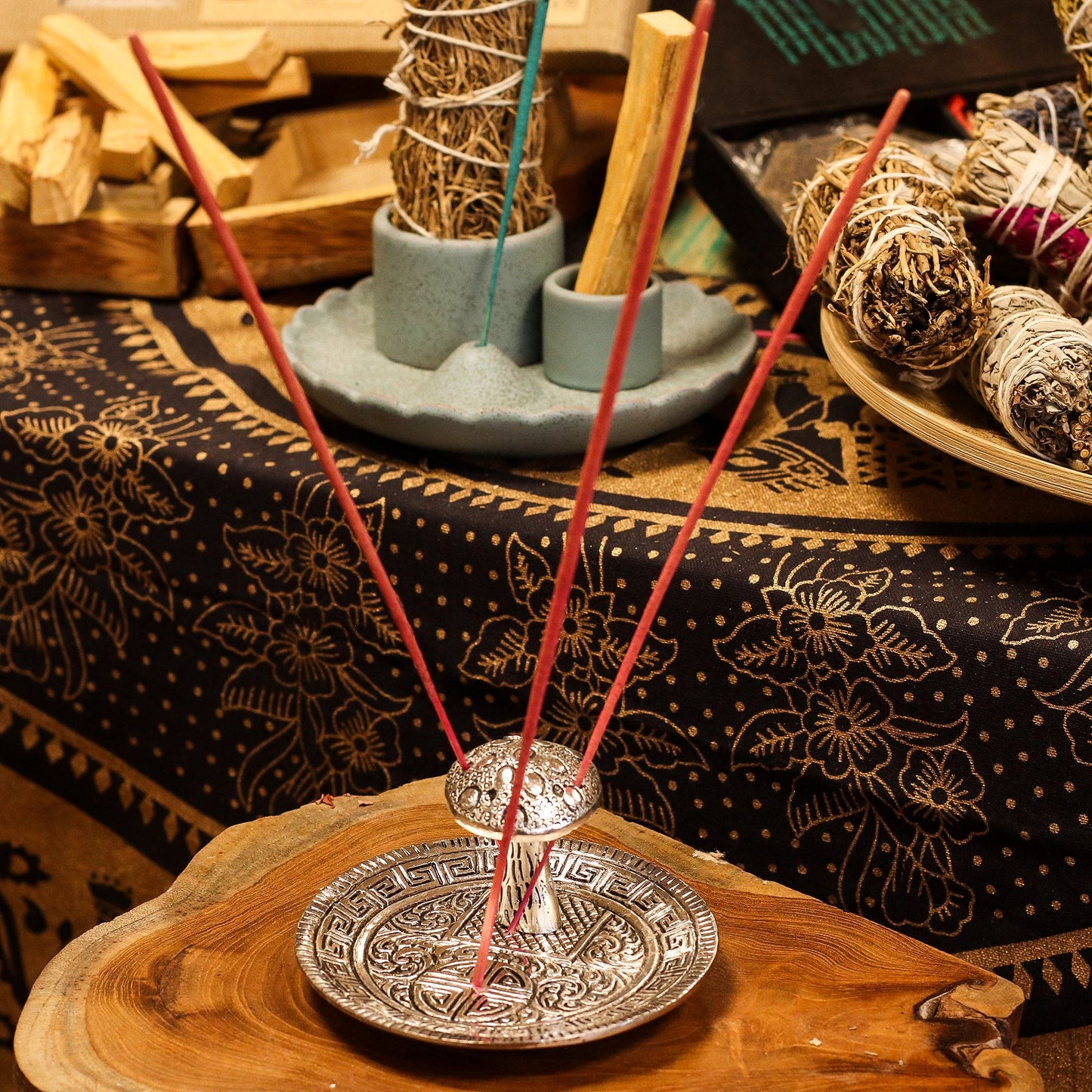 Silver effect mushroom incense holder with intricate patterned plate.