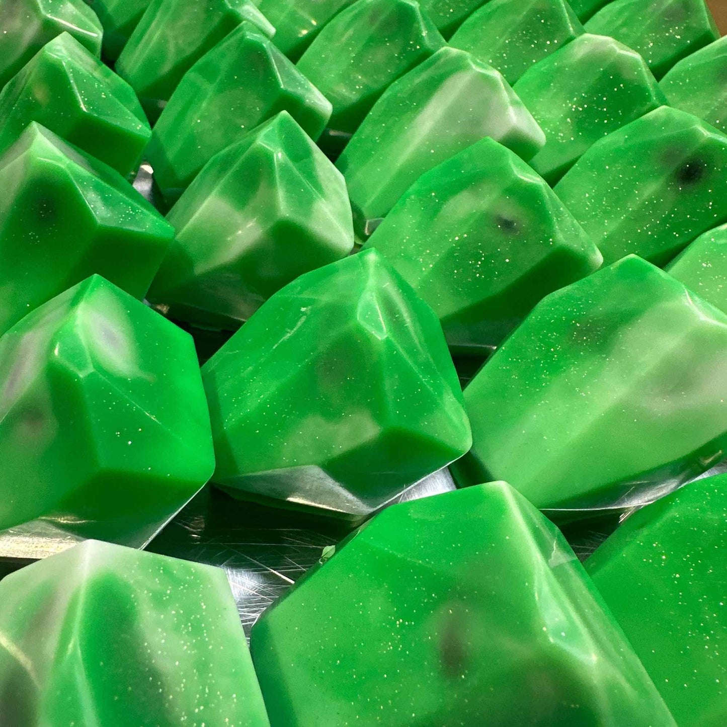 Green crystal-shaped soaps with glitter accents.