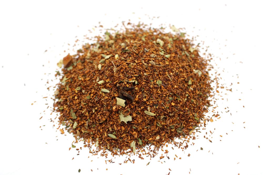 A pile of loose red bush tea with mint and star anise.