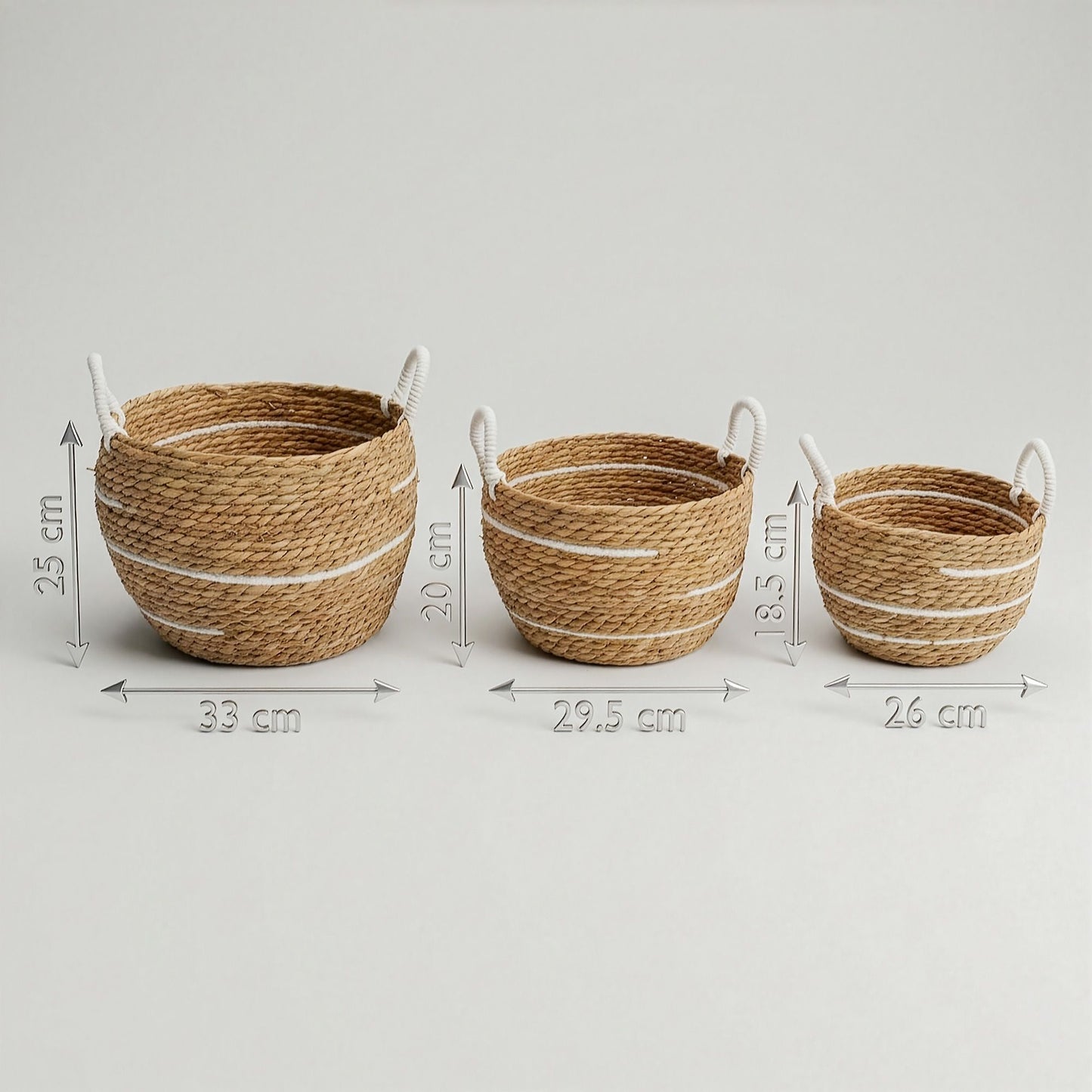 Set of three natural seagrass baskets with white stripes and rope handles.