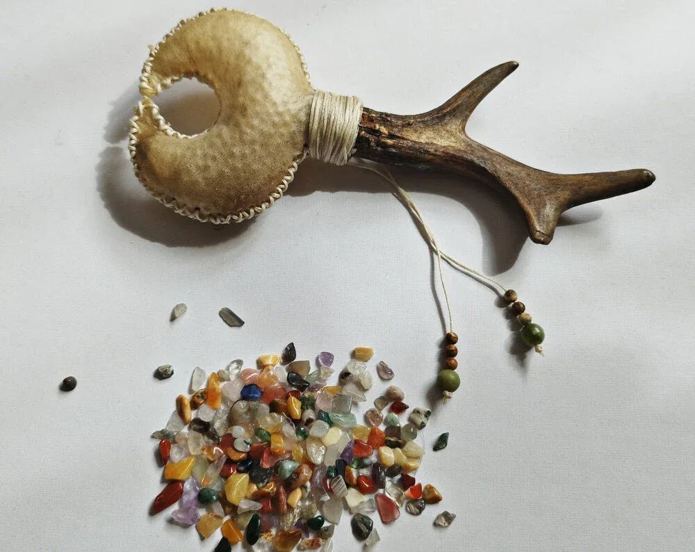 Shamanic rattle with gemstone filling and antler handle.