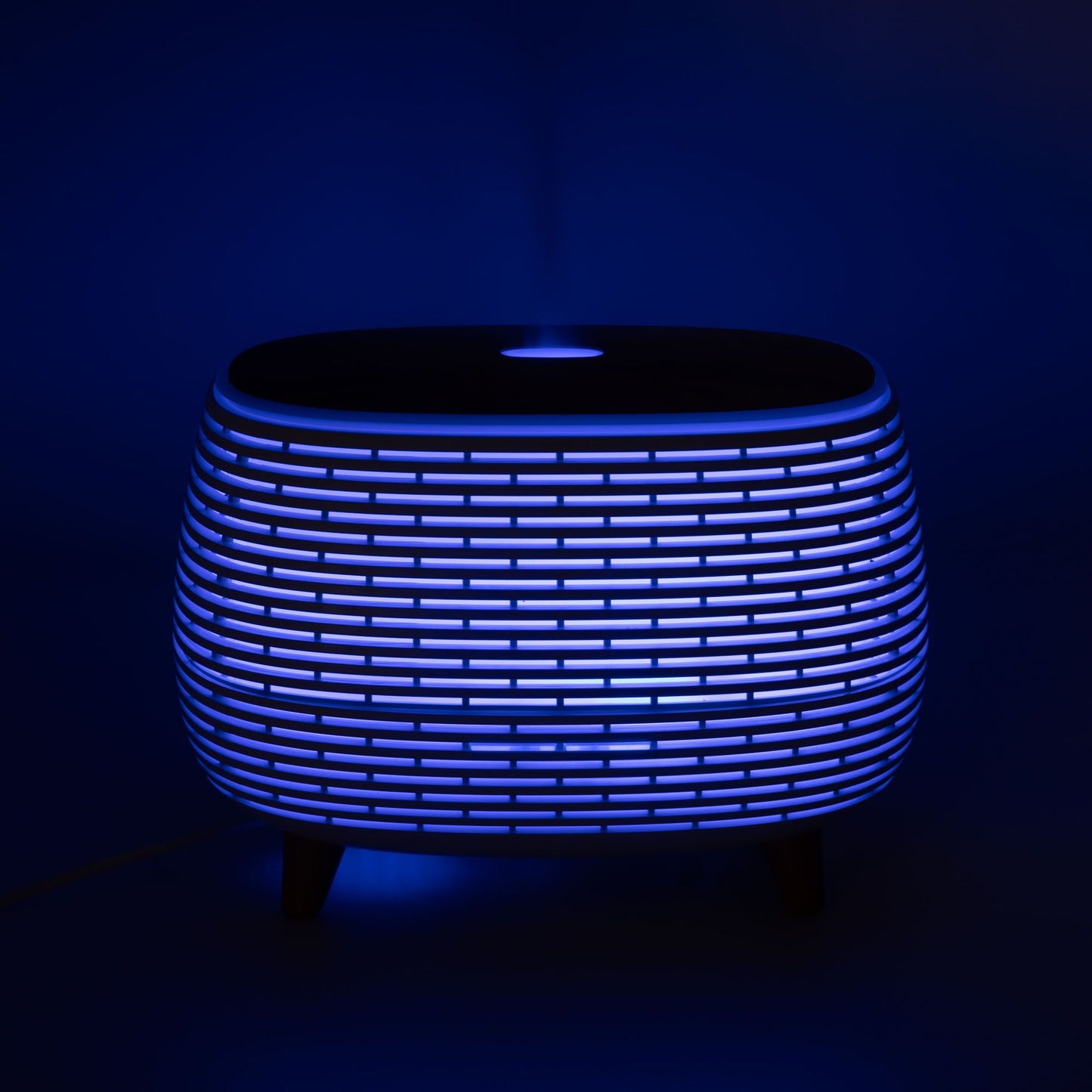 Futuristic ribbed aroma diffuser with color-changing light.