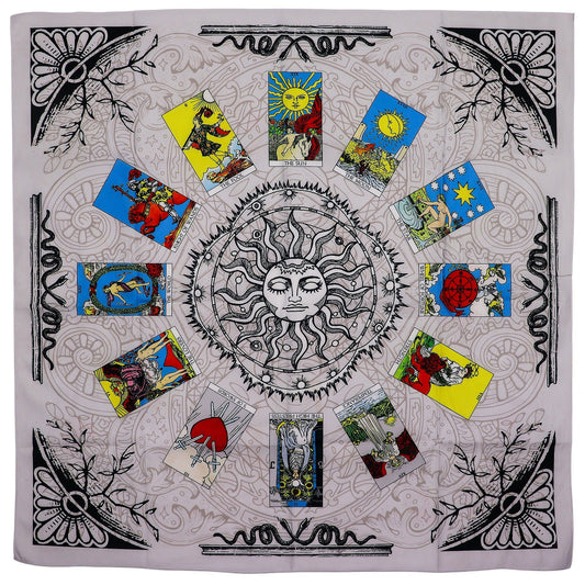 A square tarot reading cloth with a central sun design and surrounding tarot cards.