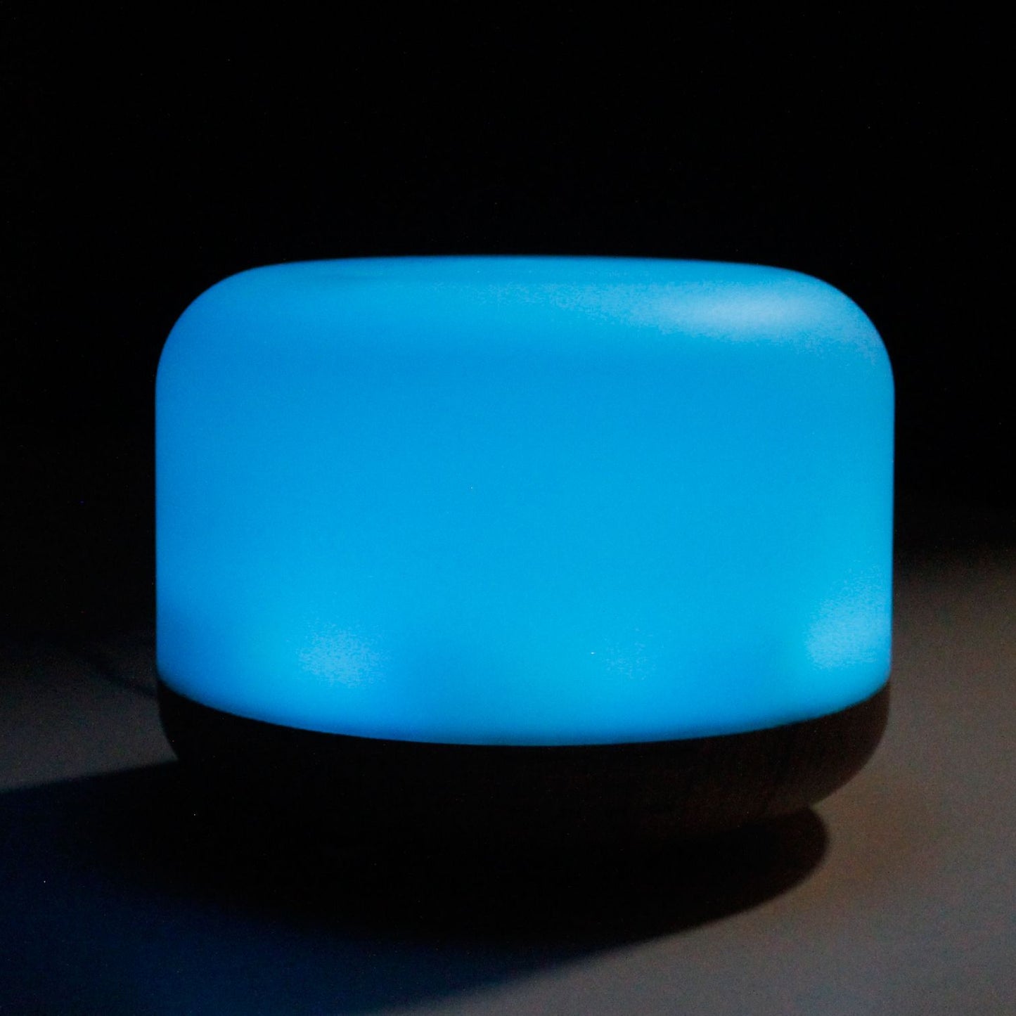 A blue, rounded aroma diffuser with a dark base.