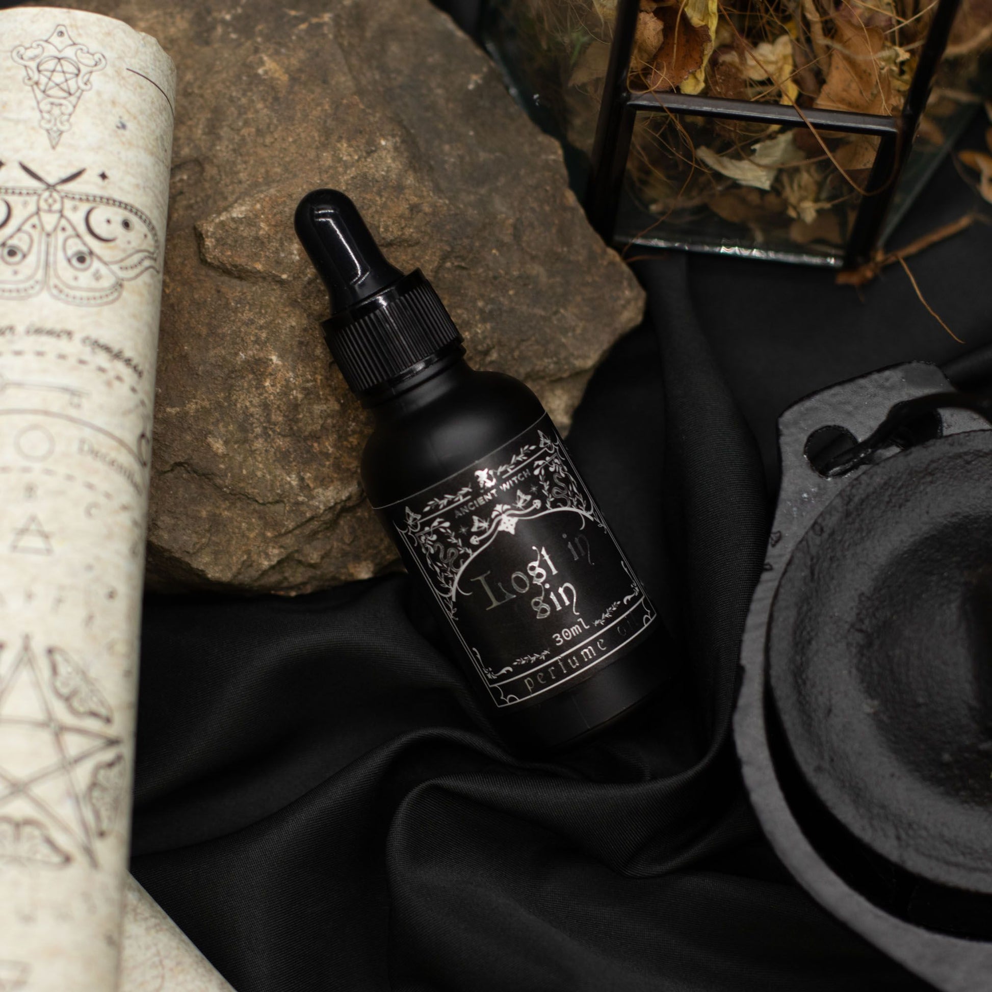 Black bottle of "Lost in Sin" perfume oil by Ancient Witch.