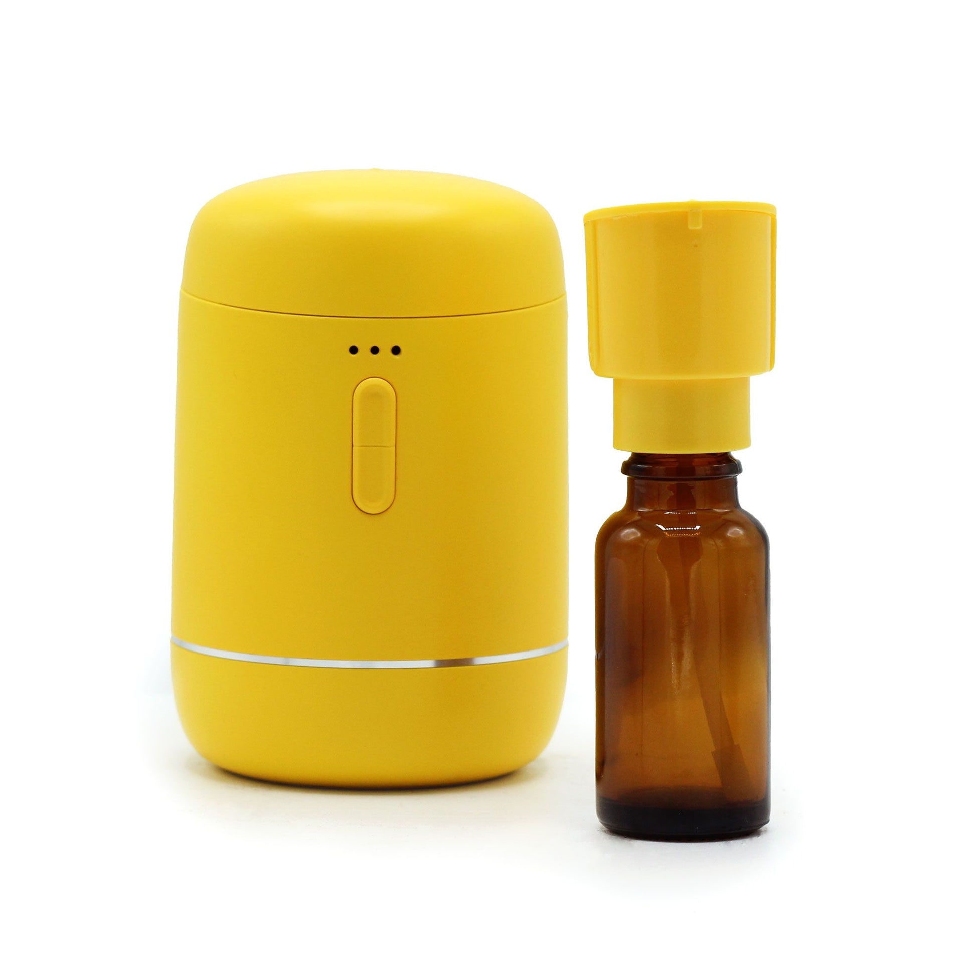 Gelber wasserloser ätherischer Öl-Diffusor mit Braunglasflasche.
