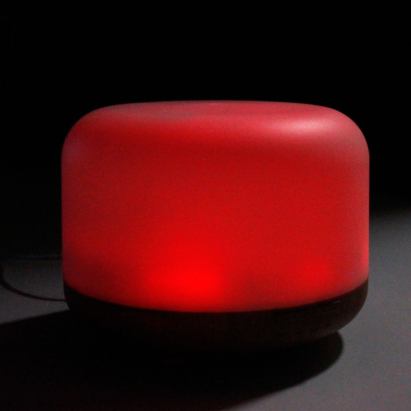 A red, rounded, USB-powered aroma diffuser with a dark base.