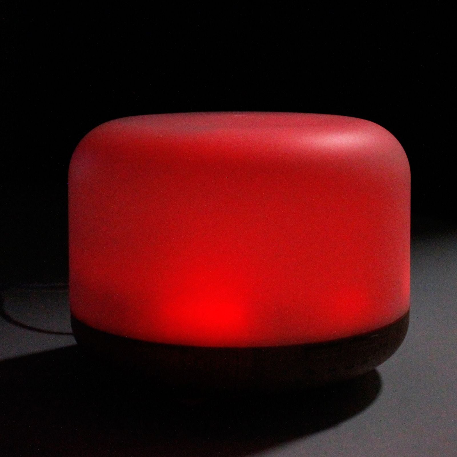 A red, rounded, USB-powered aroma diffuser with a dark base.