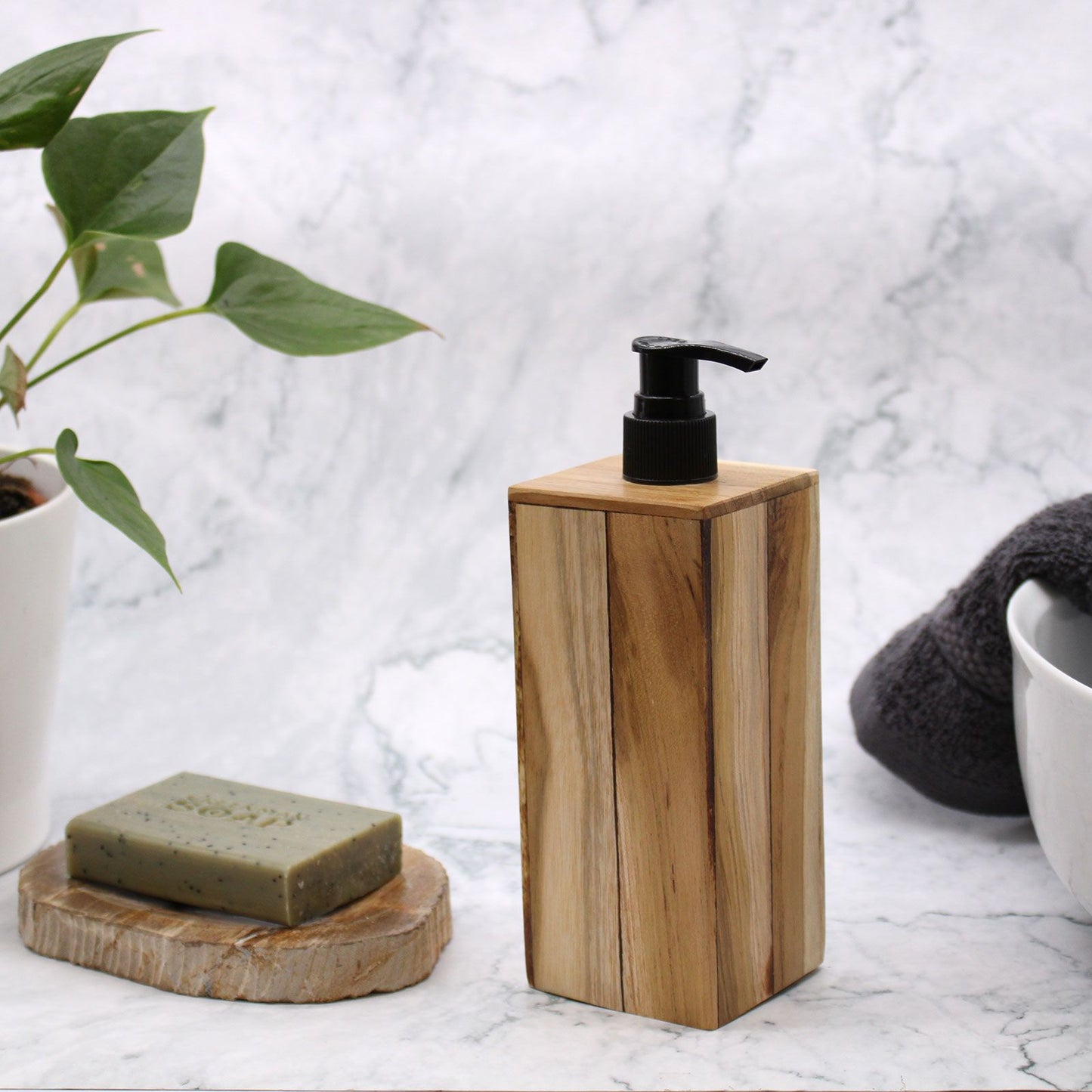 Natural teakwood square soap dispenser with a black pump.