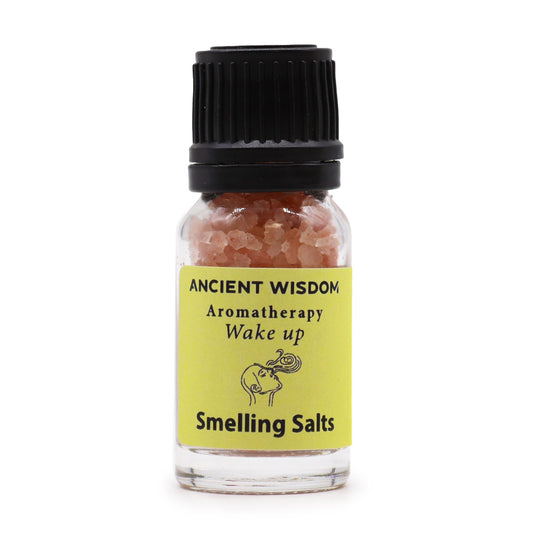 A small glass bottle of pink smelling salts with a yellow label that says "ANCIENT WISDOM Aromatherapy Wake up Smelling Salts".
