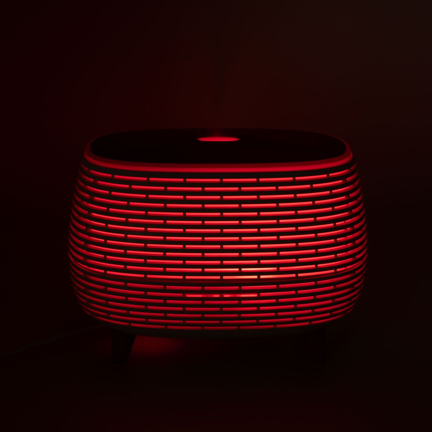Futuristic ribbed aromatherapy diffuser with red LED light.