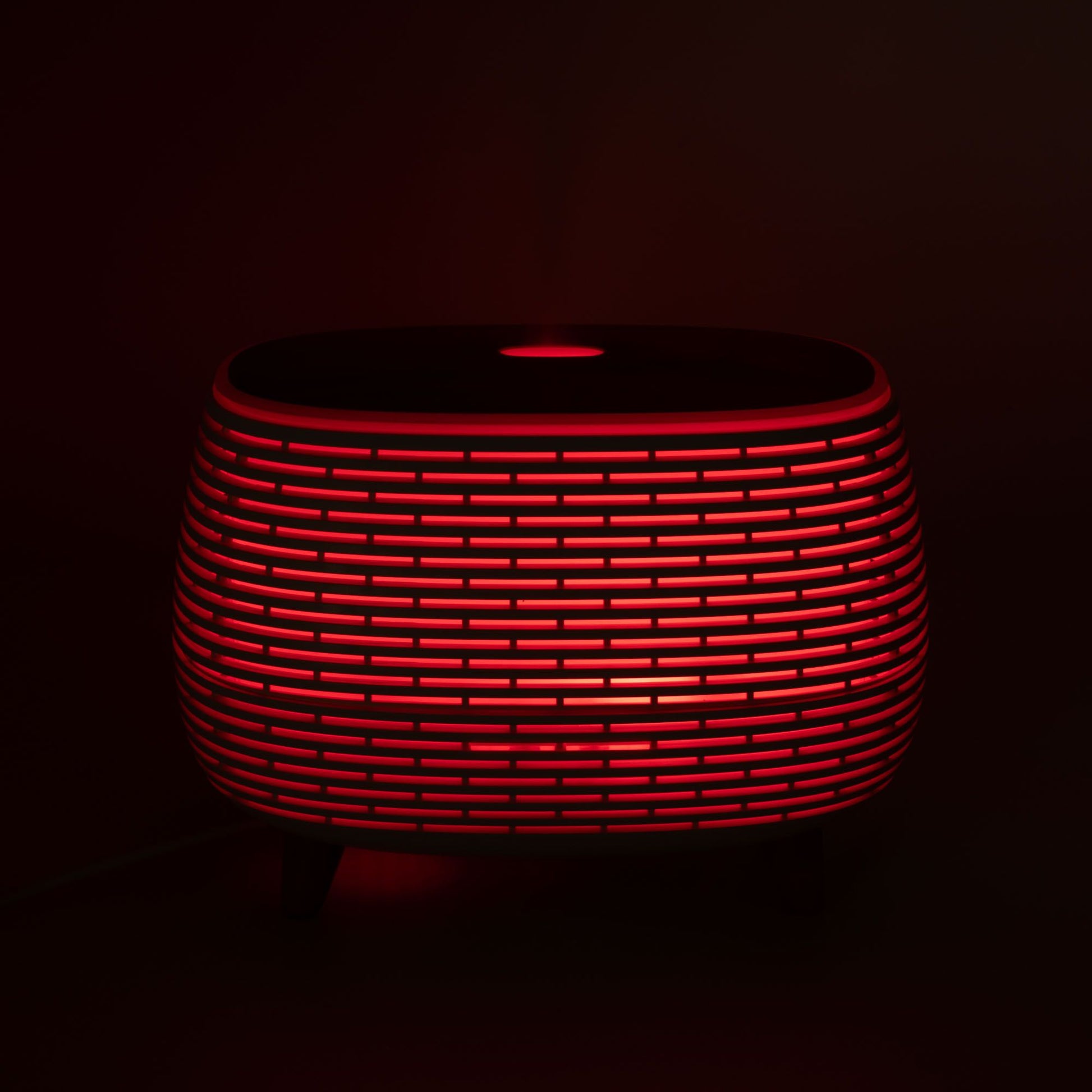 Futuristic ribbed aromatherapy diffuser with red LED light.
