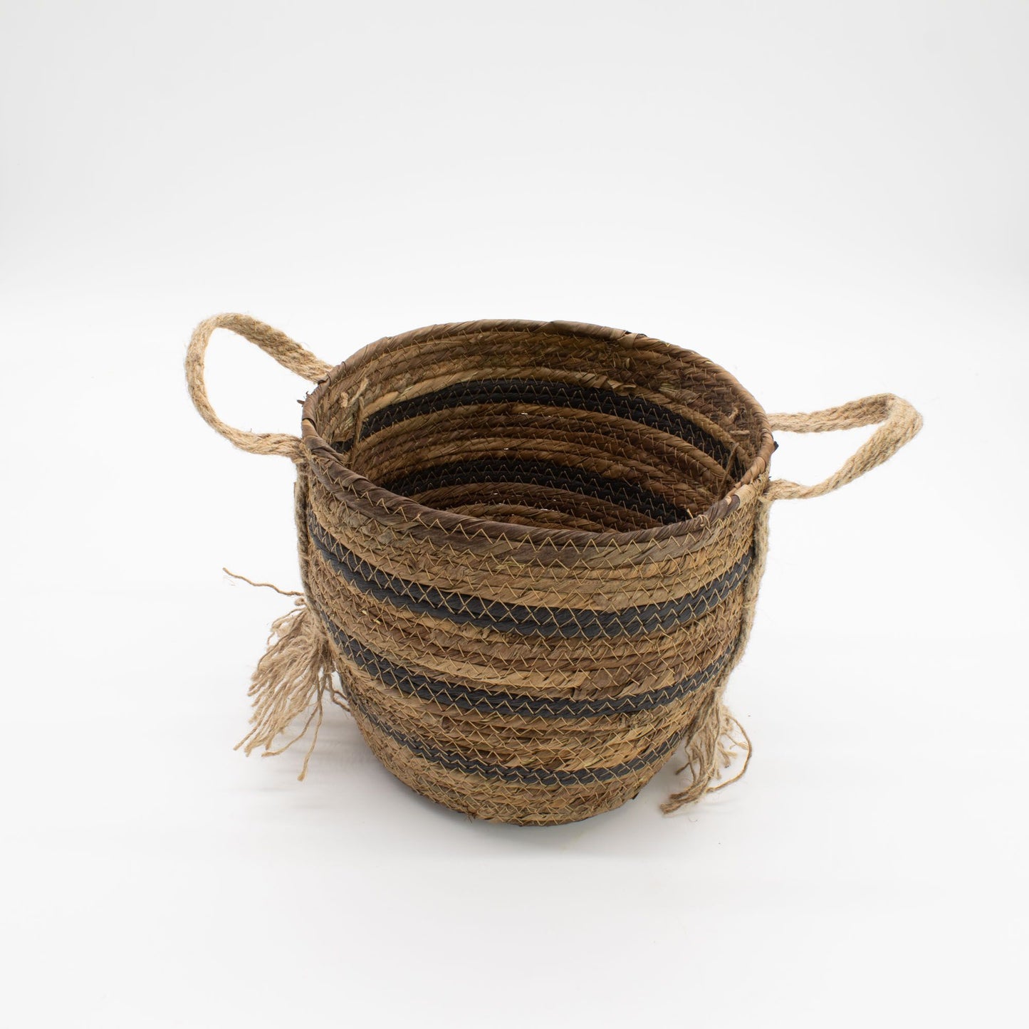 Woven seagrass basket with handles and black stripes.