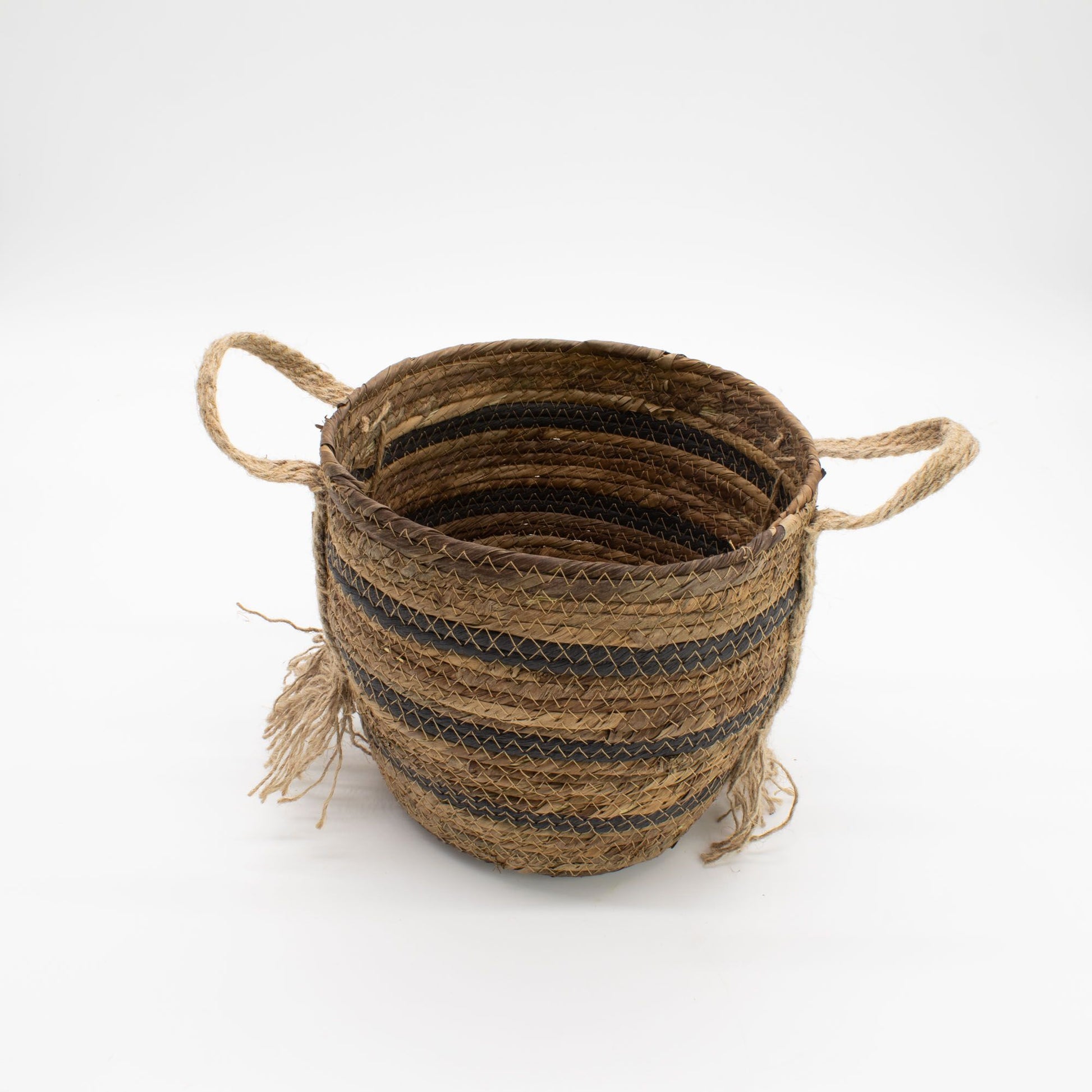 Woven seagrass basket with handles and black stripes.