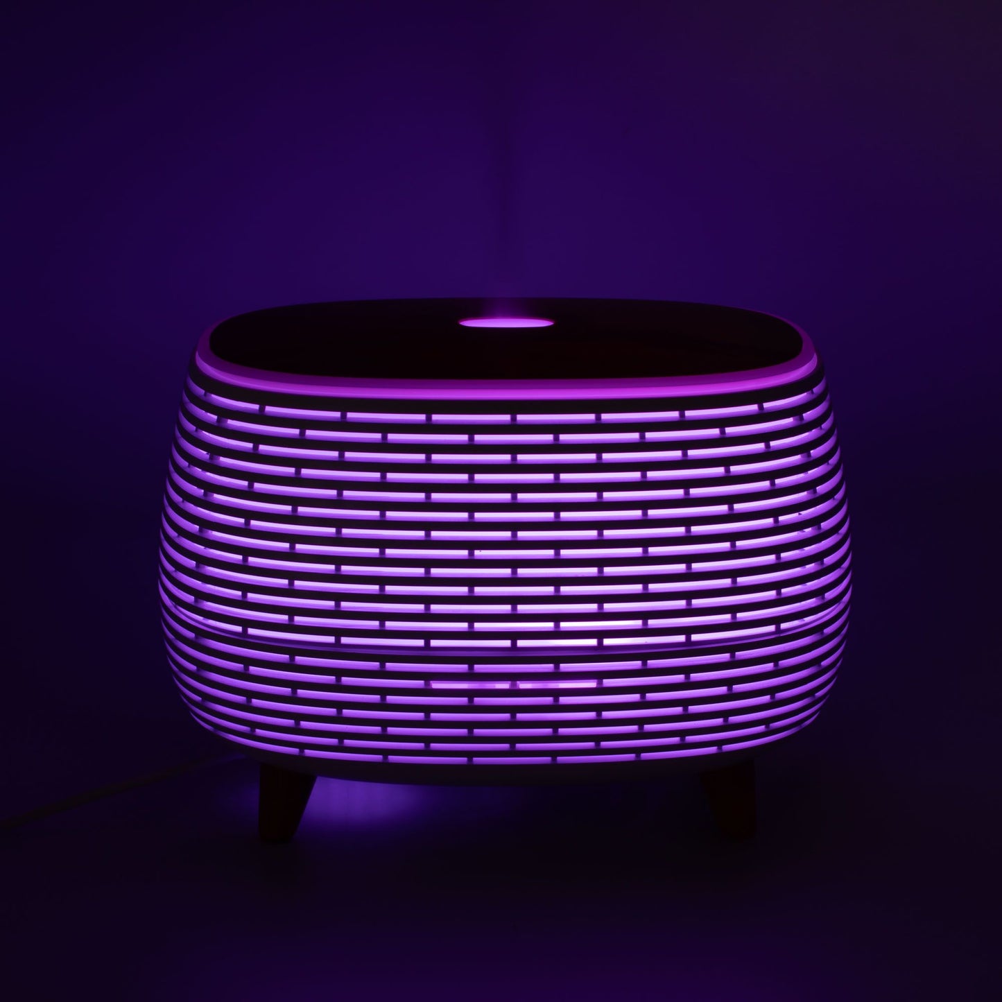 Futuristic ribbed aromatherapy diffuser with color-changing light.