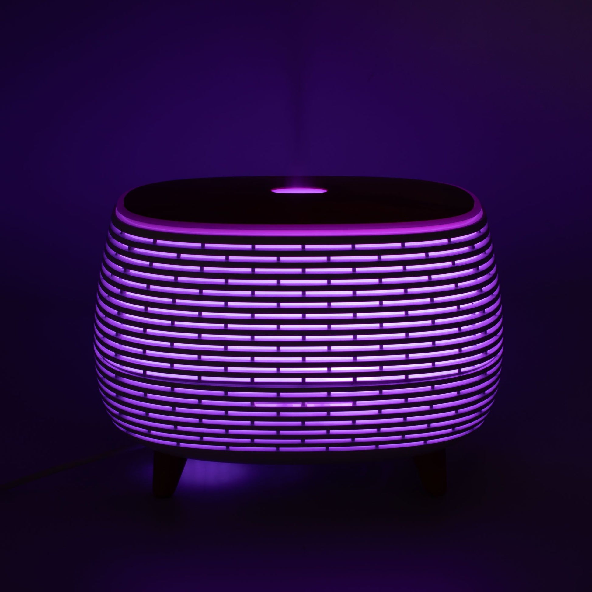 Futuristic ribbed aromatherapy diffuser with color-changing light.