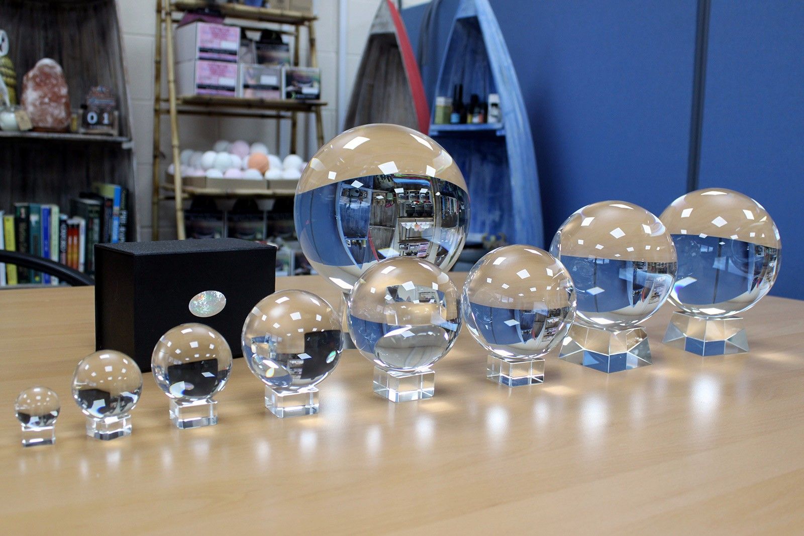 A collection of clear crystal balls of varying sizes on a wooden surface.