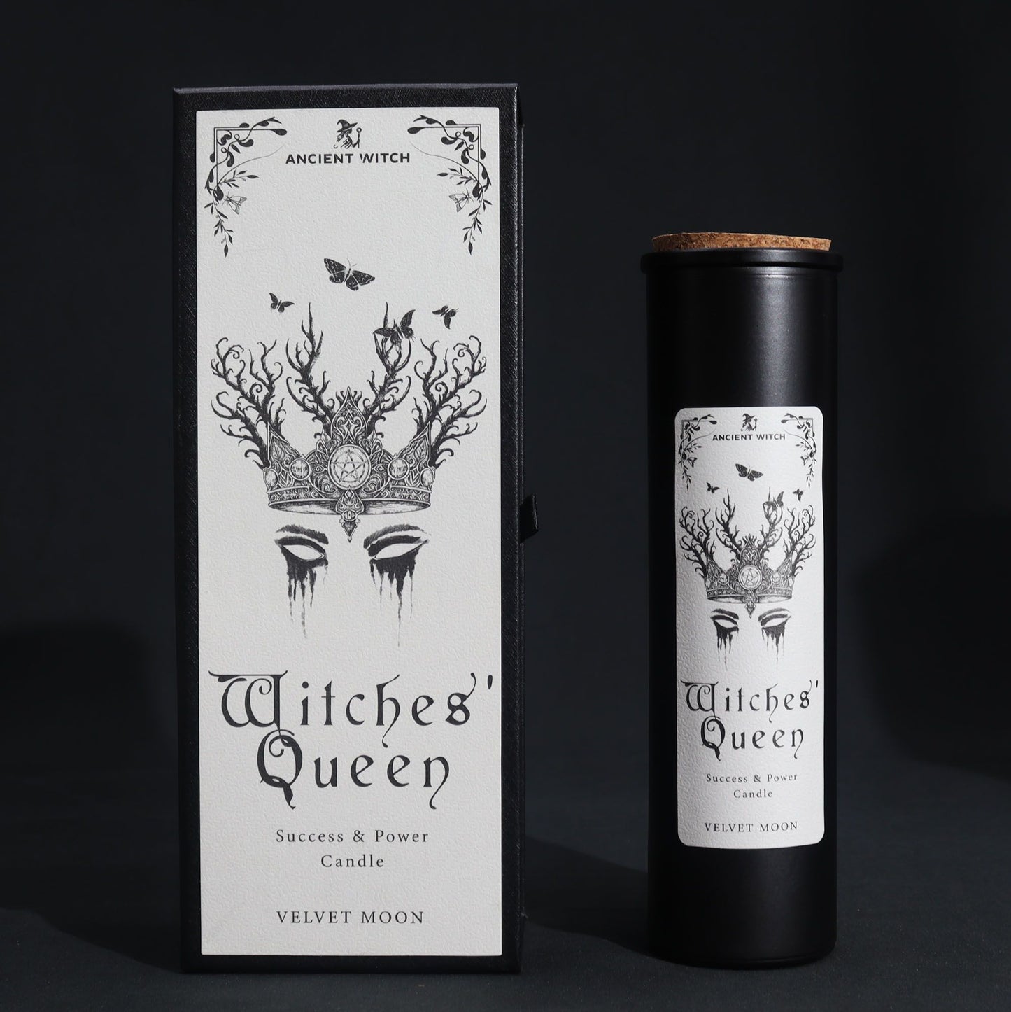 A black candle in a cylindrical container with a label featuring a crown and the text "Witches' Queen".