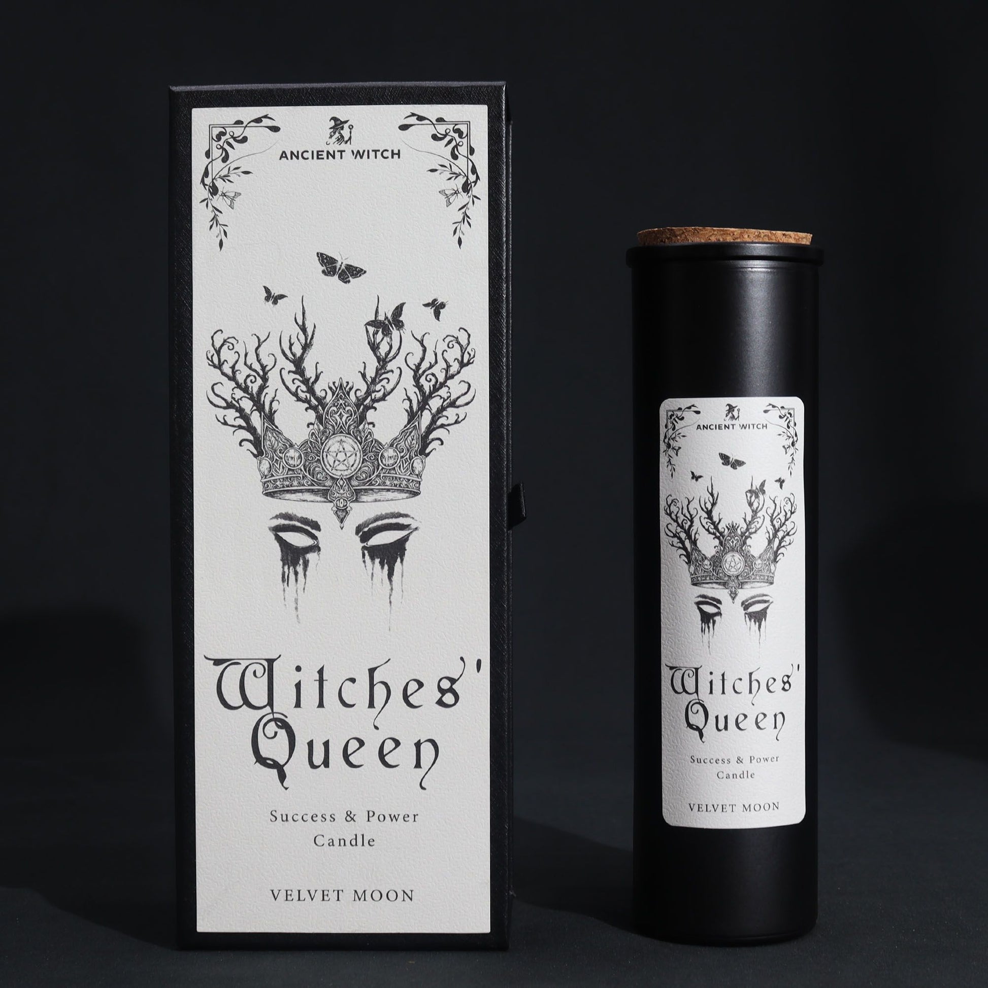 A black candle in a cylindrical container with a label featuring a crown and the text "Witches' Queen".