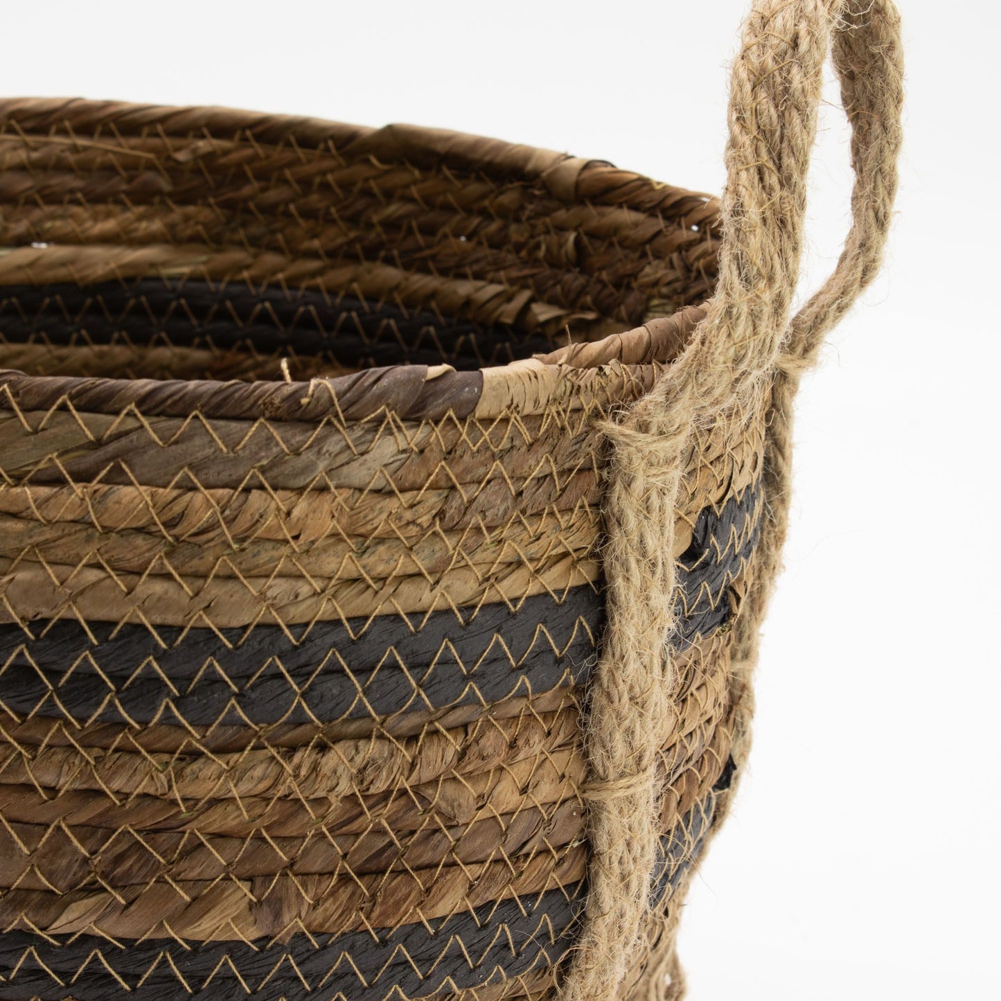 Woven banana leaf and seagrass basket with rope handles and striped pattern.