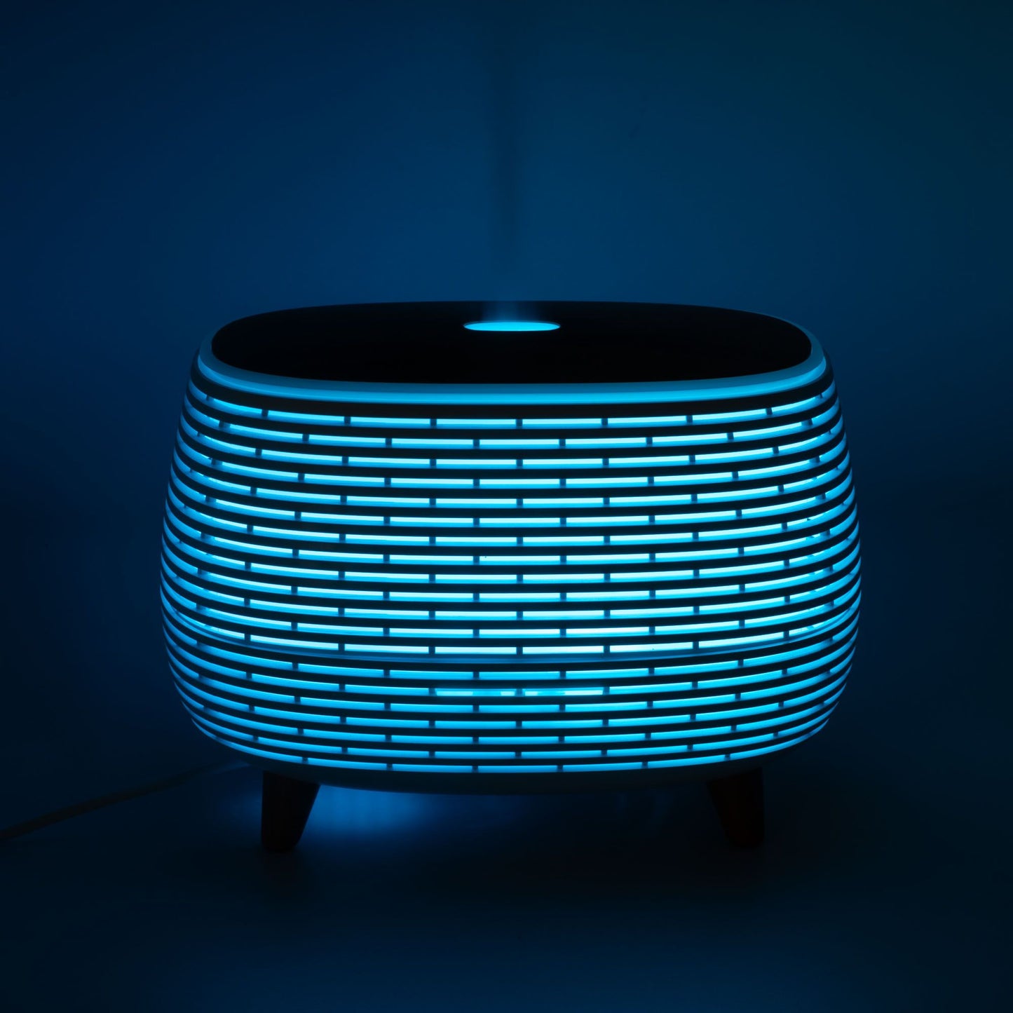 Futuristic ribbed aroma diffuser with color-changing LED light.