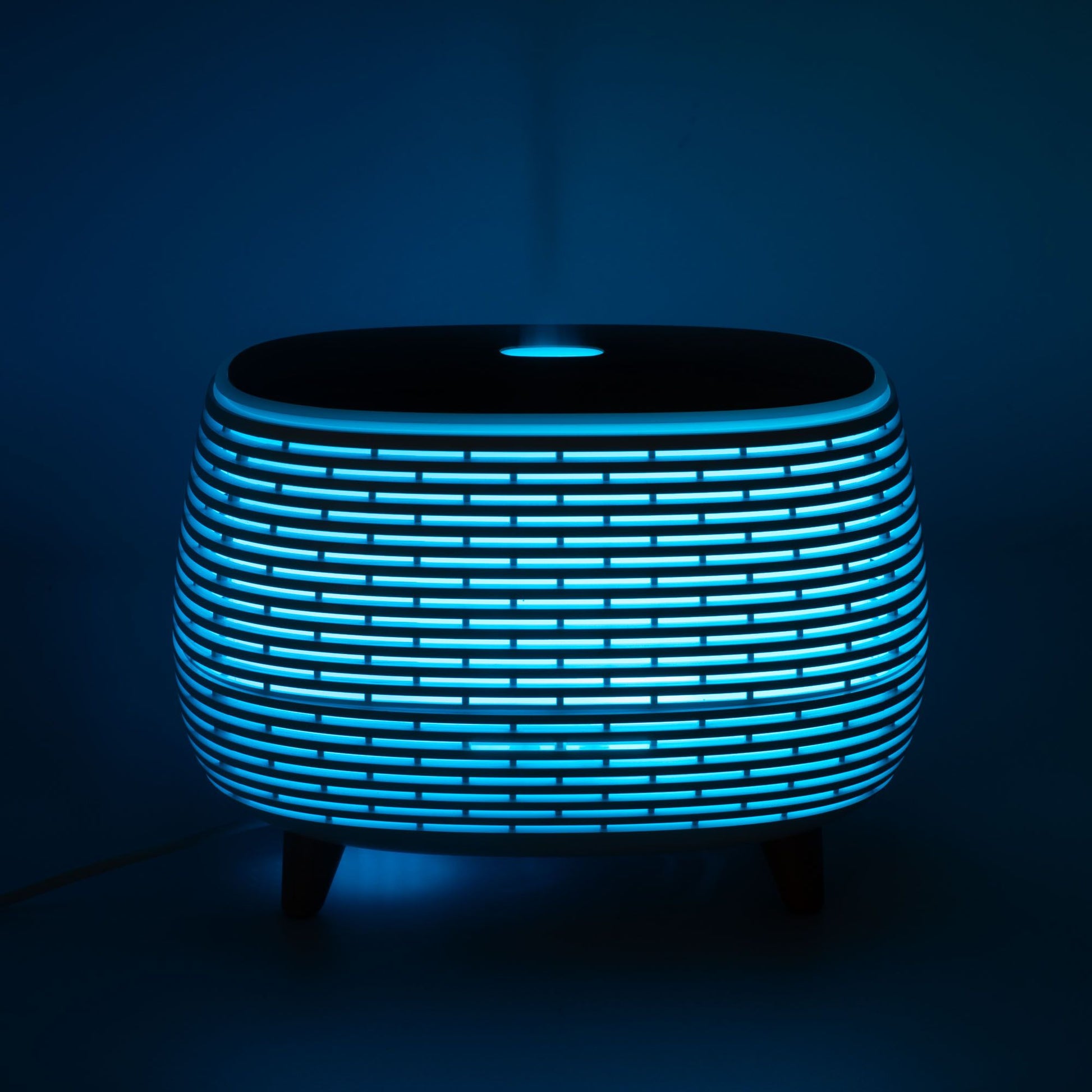 Futuristic ribbed aroma diffuser with color-changing LED light.