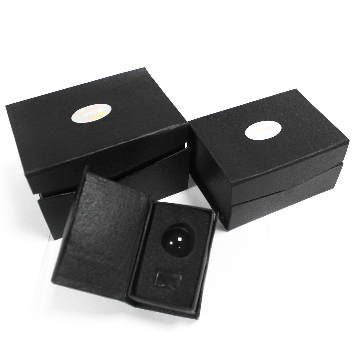 Two black boxes with a crystal ball on a stand inside one of them.