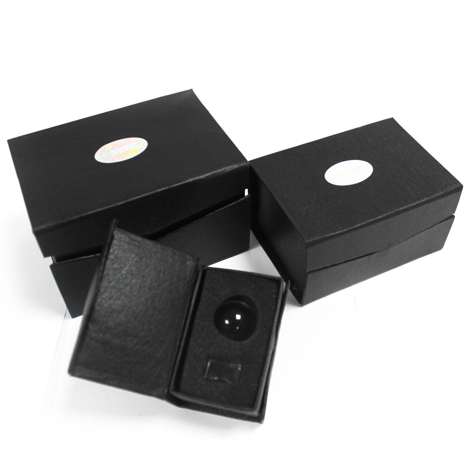 Two black boxes with a crystal ball on a stand inside one of them.
