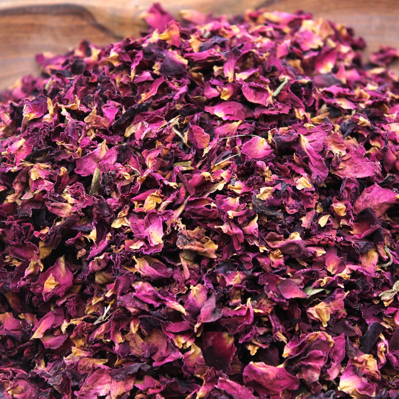 Dried rose petals in shades of deep pink and yellow.