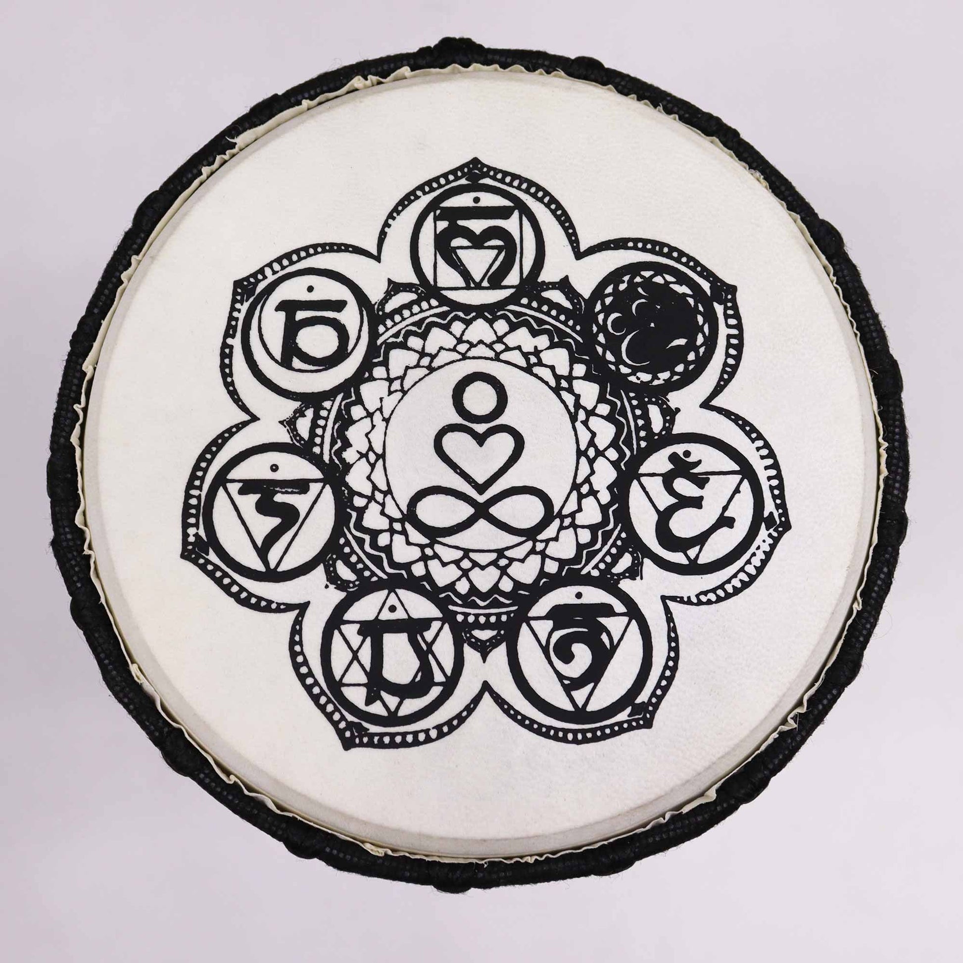 Handmade djembe drum with a black and white chakra design.