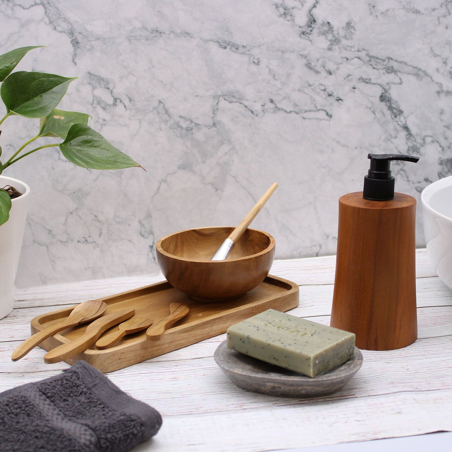 Natural teakwood soap dispenser with a tapered design.