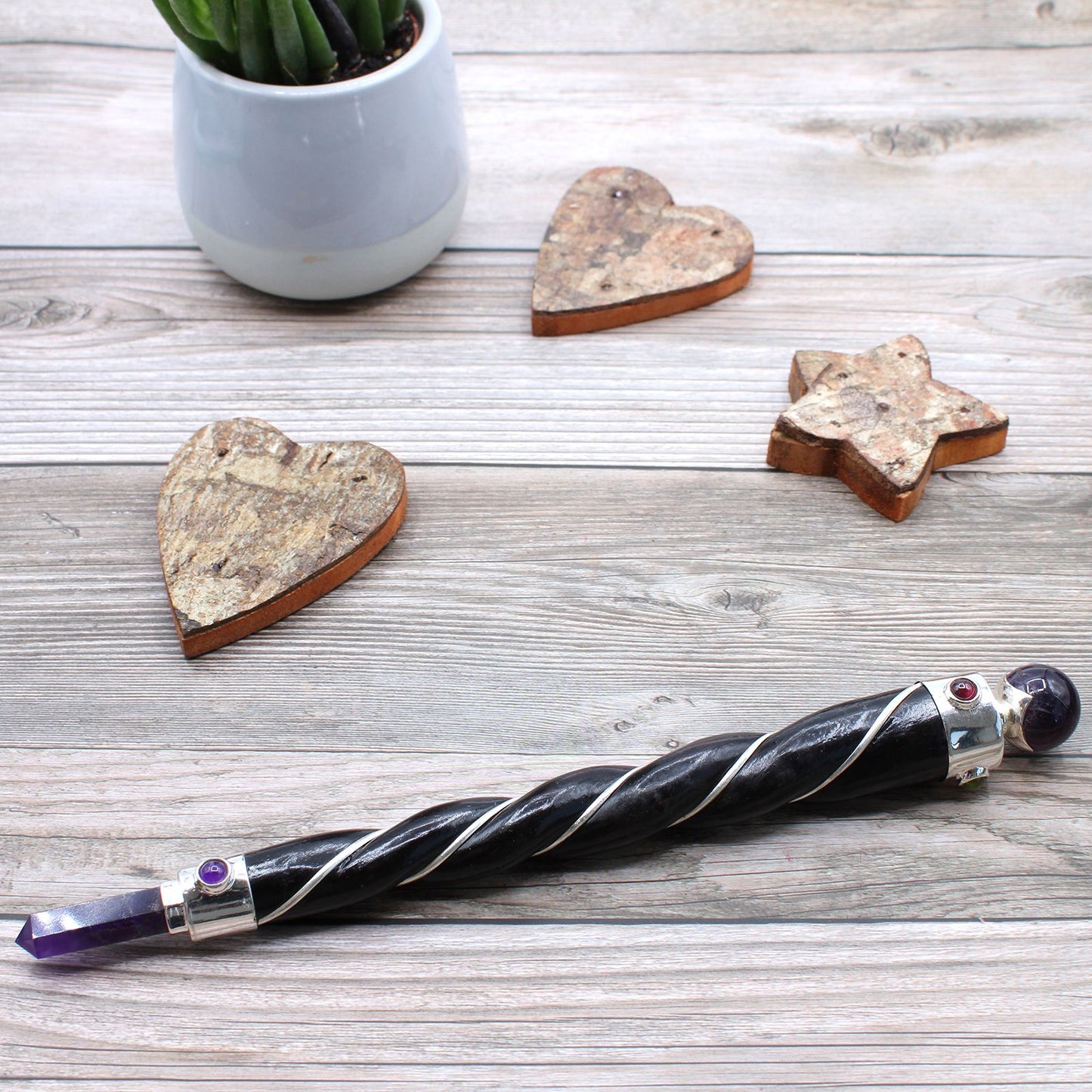 Twisted healing wand with silver accents, amethyst point, and sphere.
