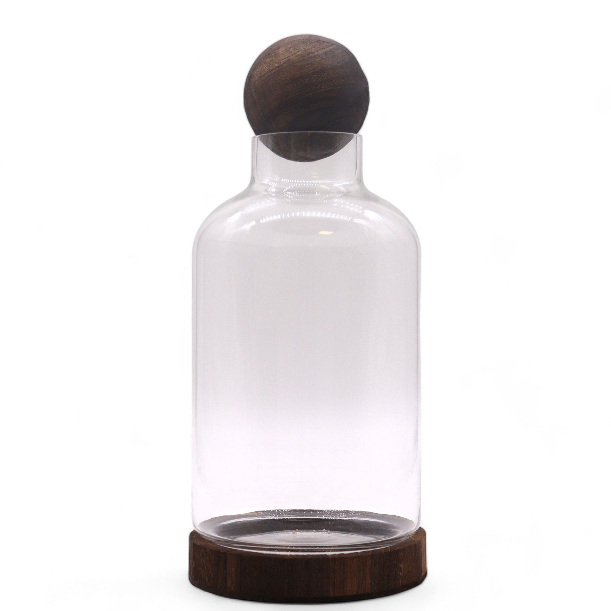 Tall glass terrarium with a wooden ball top and dark wood base.