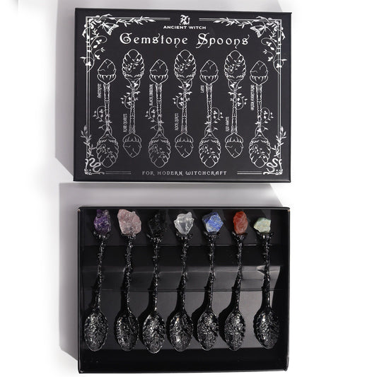 Set of 7 dark silver spoons with raw gemstone crystals on the handles.