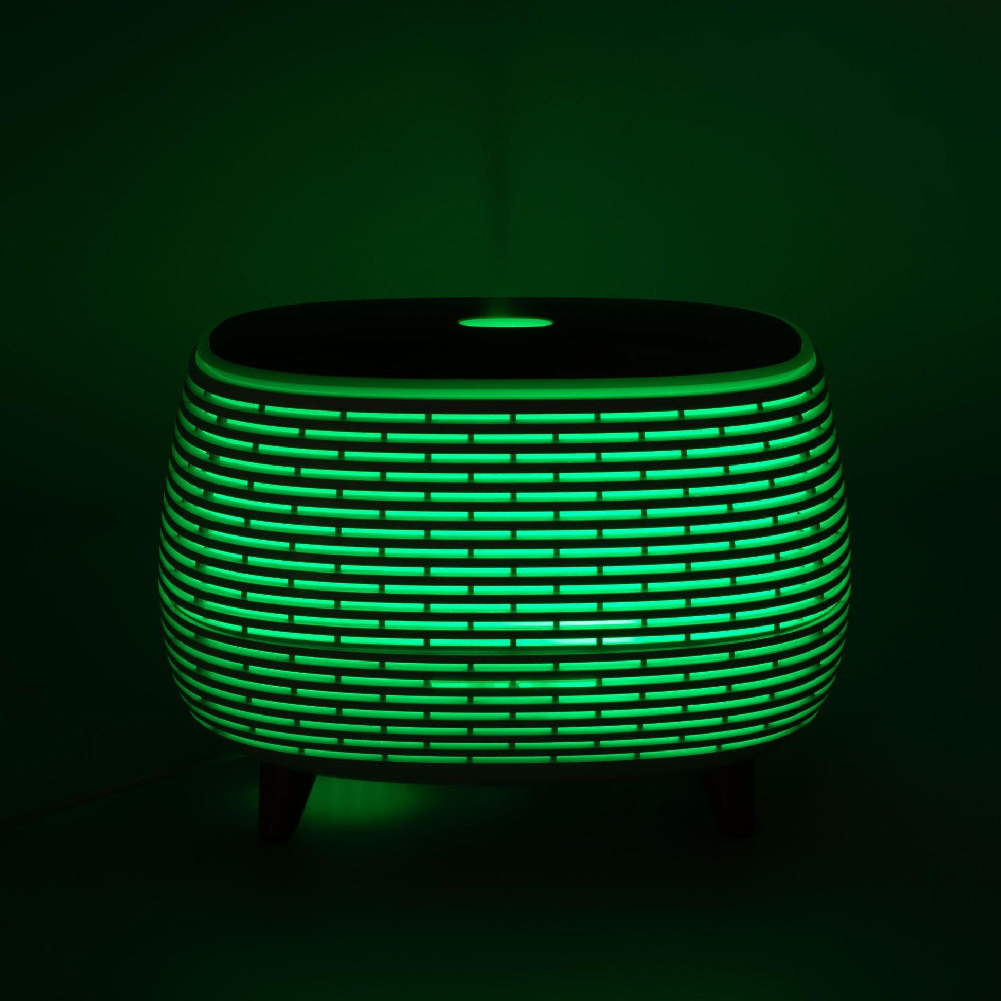 Futuristic ribbed aroma diffuser with green LED light.