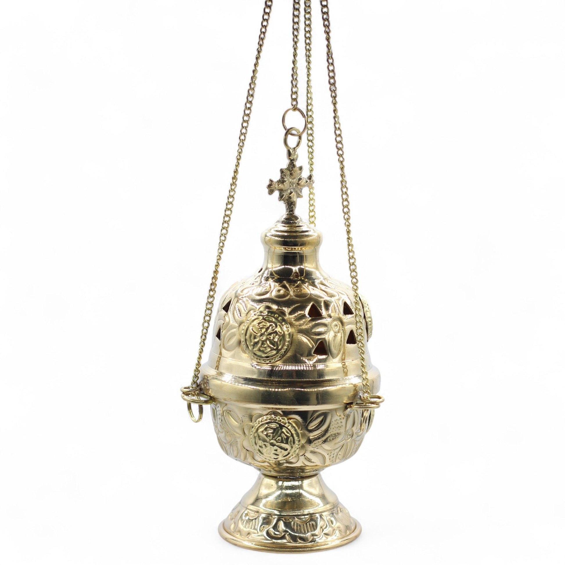 Hanging brass incense burner with intricate floral engravings and a cross finial.