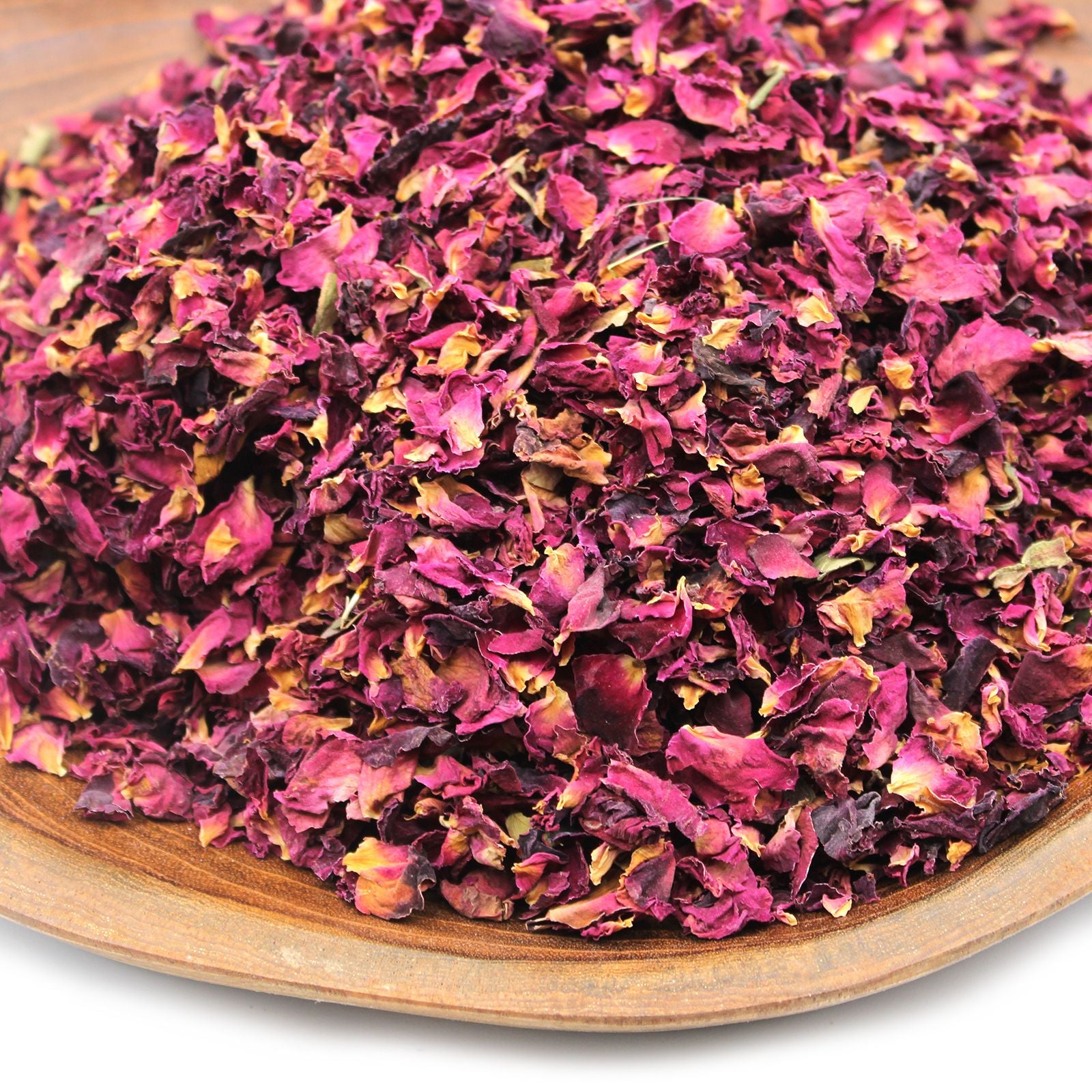Dried rose petals in a wooden bowl.
