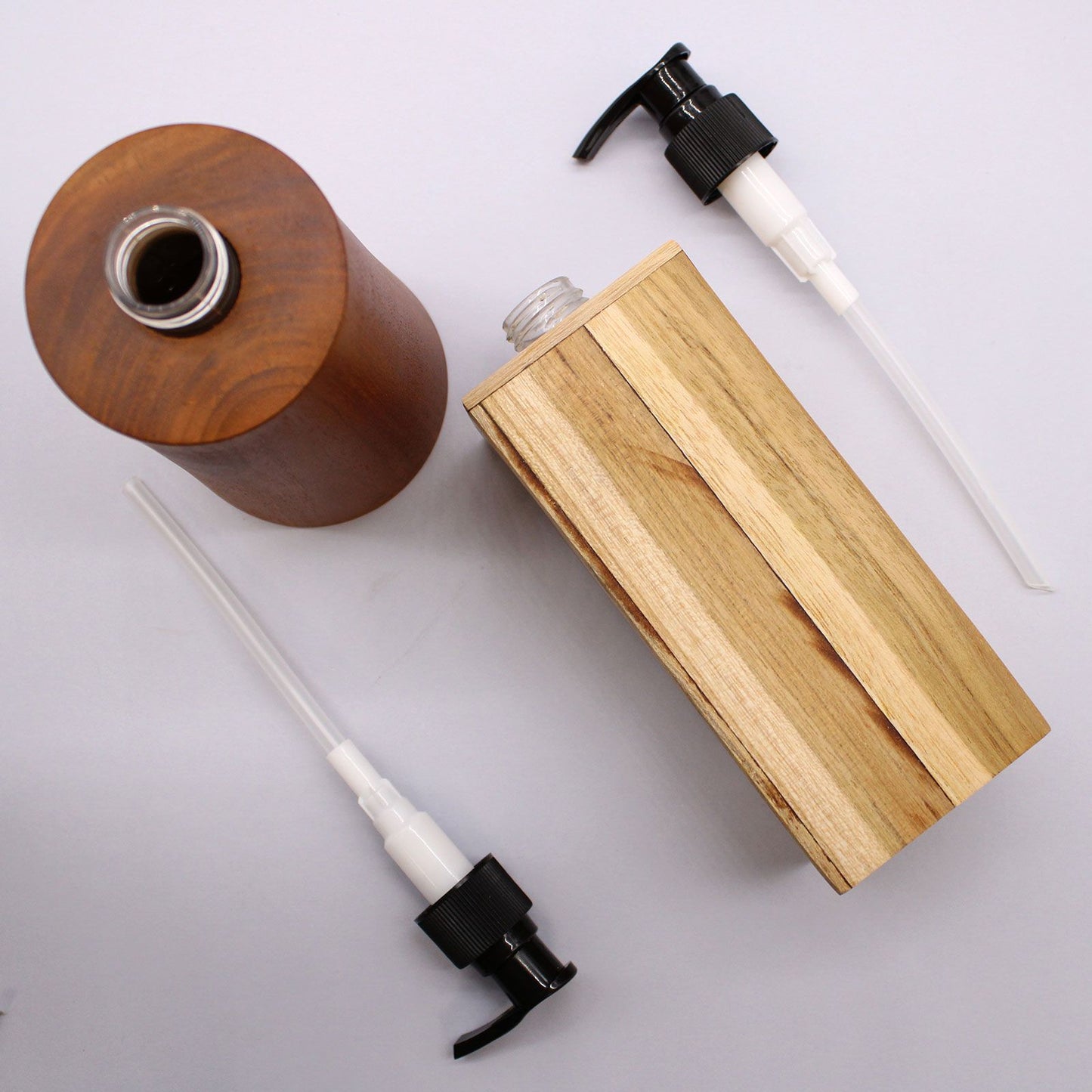 Natural teakwood soap dispenser with a pump top.