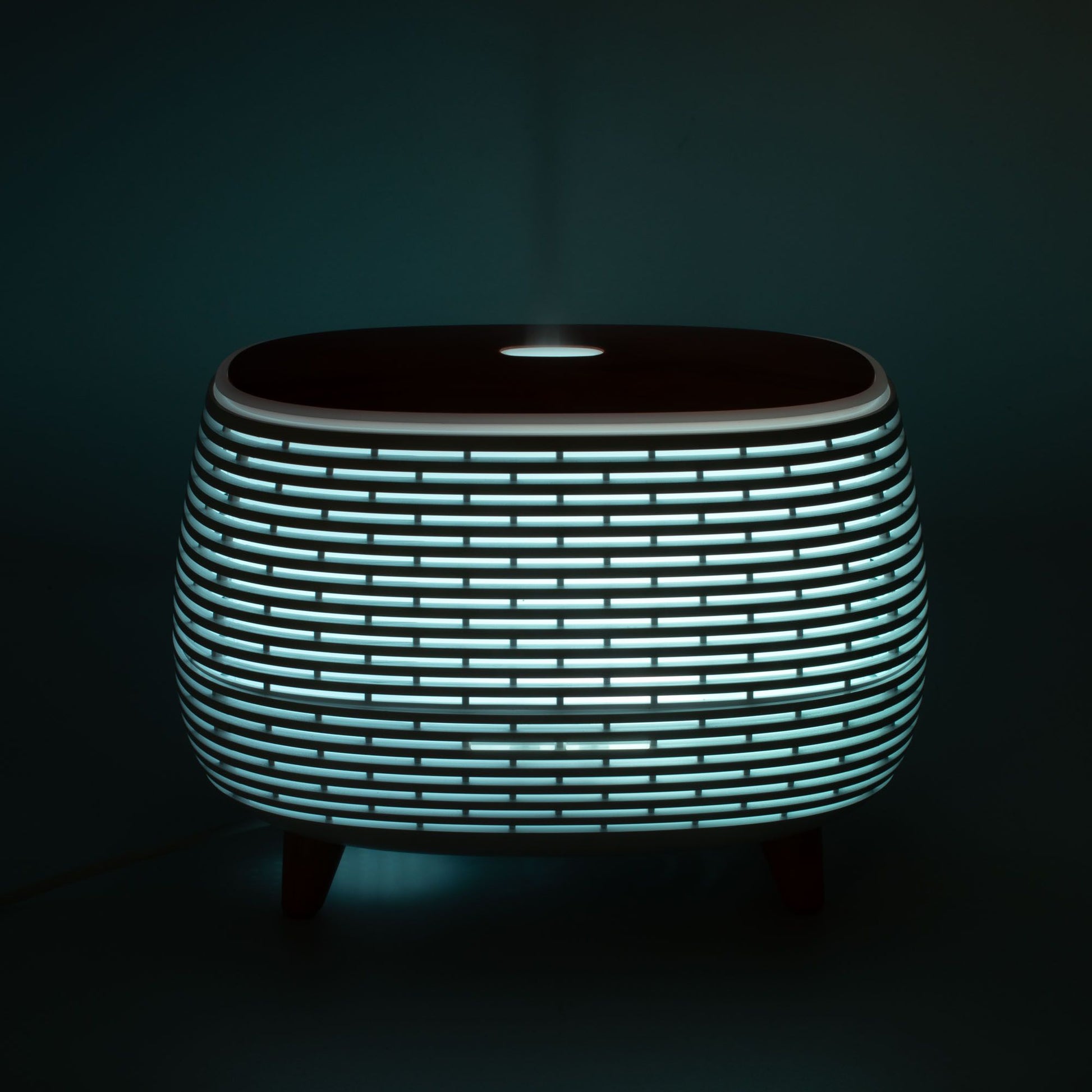 Futuristic ribbed aroma diffuser with color-changing light.