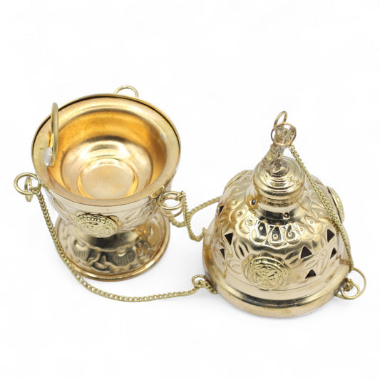 Hanging brass incense burner with intricate carvings and a chain.