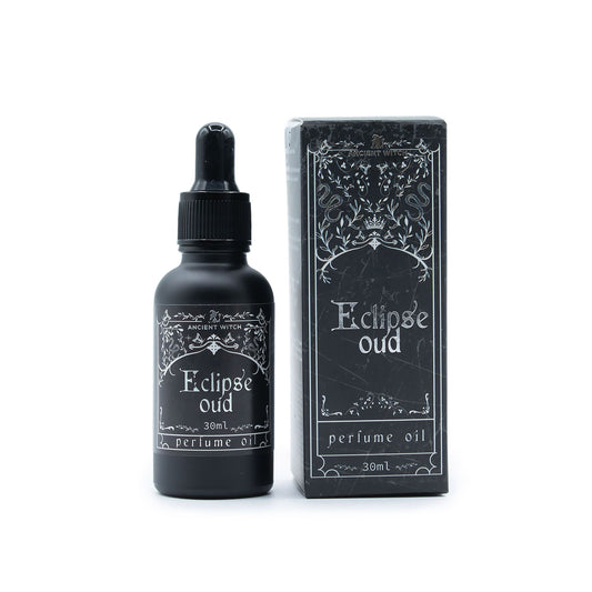 A black bottle of Eclipse Oud perfume oil and its matching box.