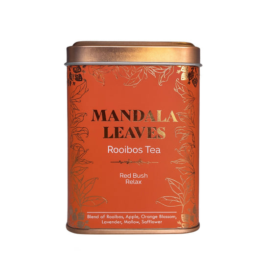 Orange tin of Mandala Leaves Rooibos Tea with gold leaf design.