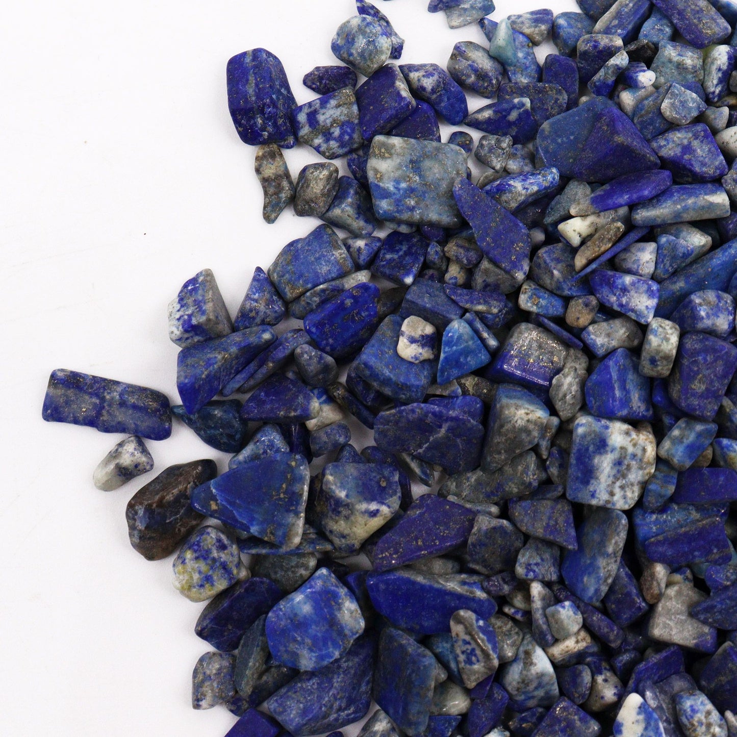 Tumbled lapis lazuli chips with deep blue and gold pyrite inclusions.