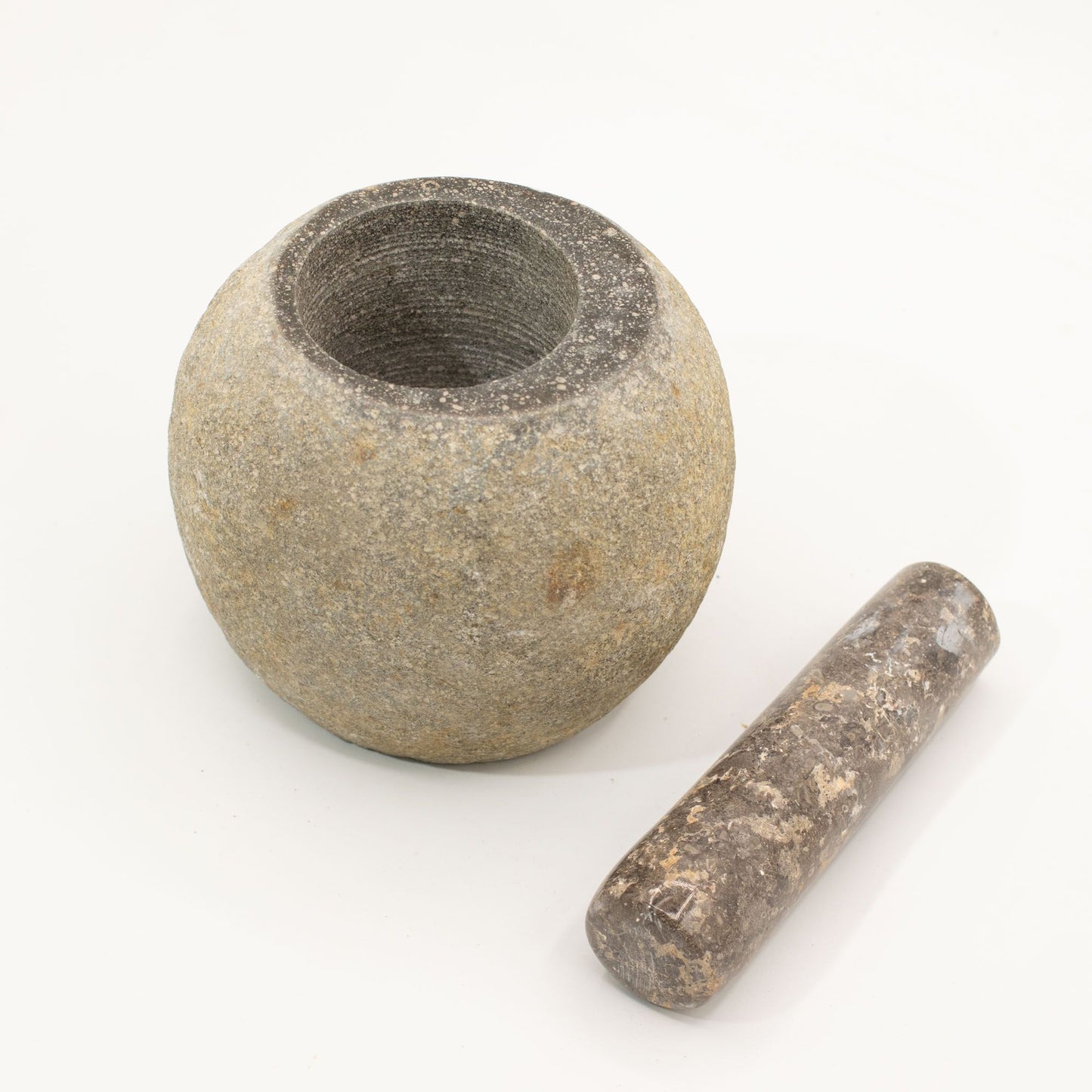 Handgefertigter großer Mörser mit Stößel aus grauem Naturstein.