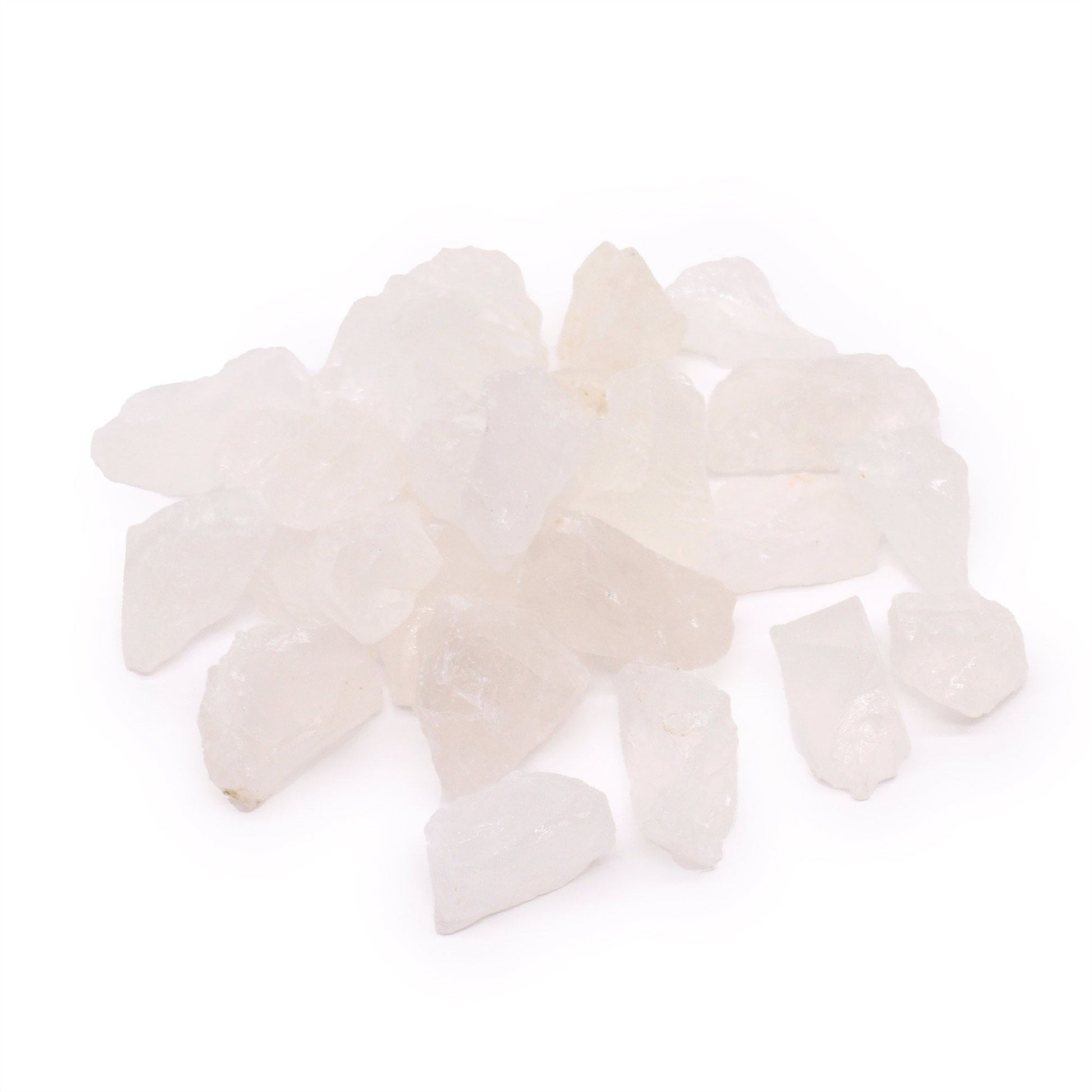 A pile of rough, clear to milky white quartz crystals on a white background.