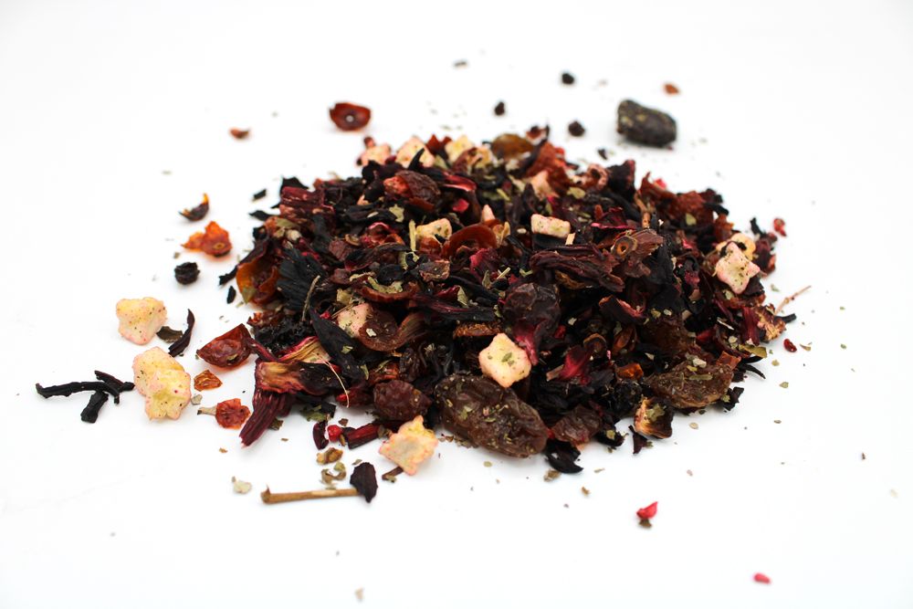 A pile of dried fruit and hibiscus tea blend with visible pieces of apple and berries.
