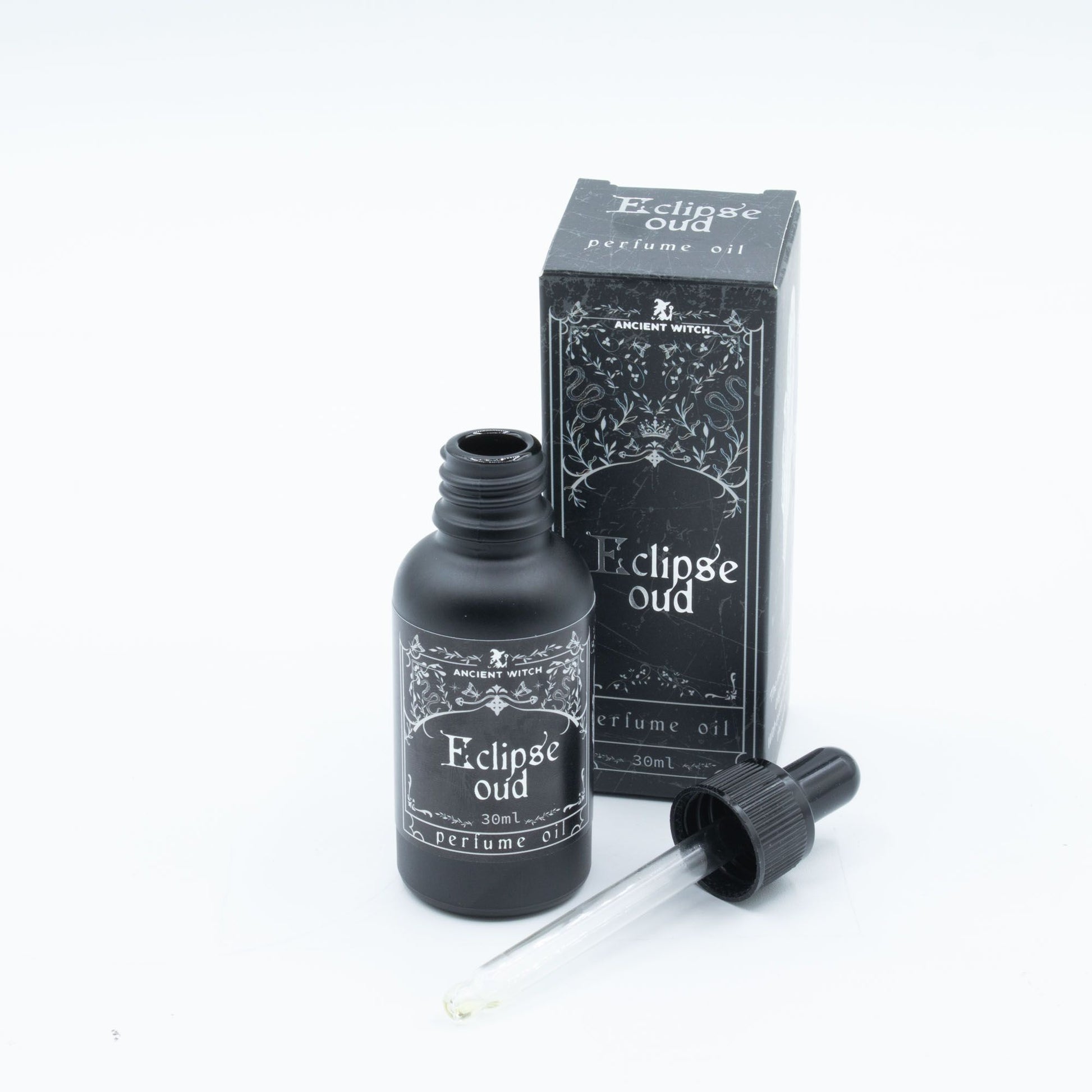 Ancient Witch Eclipse Oud perfume oil in a black bottle with a dropper.