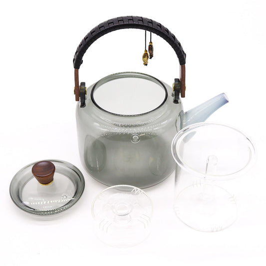 Graue Glas-Teekanne mit Holzgriff und integriertem Sieb.